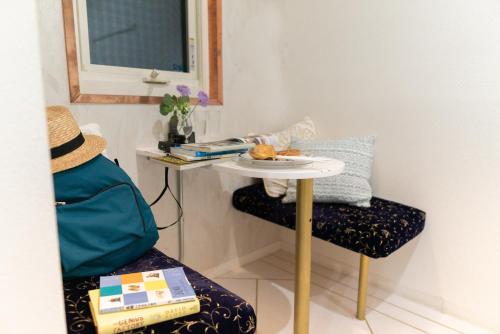 a table and a chair with a plate of food on it at Casa Blanca Guesthouse in Nagasaki