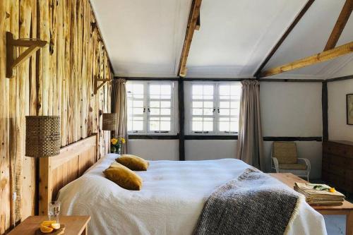 ein Schlafzimmer mit einem großen Bett mit Kissen darauf in der Unterkunft Dream the Days away by Yourhost The Rustic Barn Nanyuki Kenya in Nanyuki