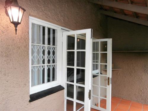 a pair of white doors next to a wall at The Courthouse in Ramsgate