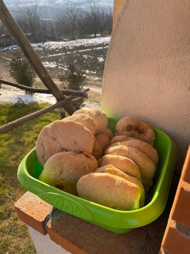 a green bowl filled with breads on a wall at Wineyards Salin in Turda