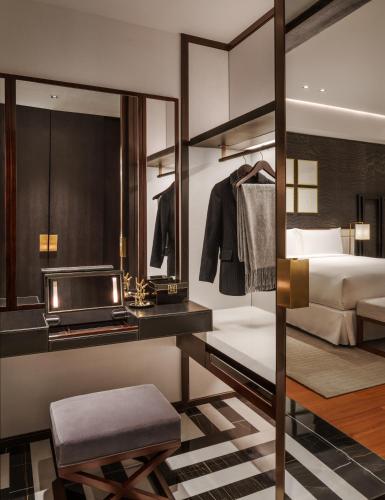 a hotel room with a bed and a mirror at Fairmont Wuhan in Wuhan