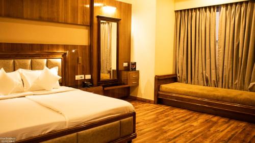 a hotel room with a bed and a window at The Grand Shekhawati in Rāmsir