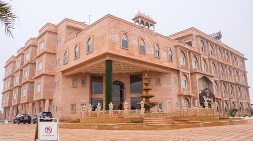 a large wooden building with a fountain in front of it at The Grand Shekhawati in Rāmsir