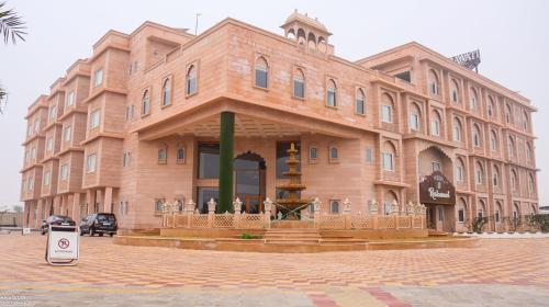 a large brick building with a fountain in front of it at The Grand Shekhawati in Rāmsir