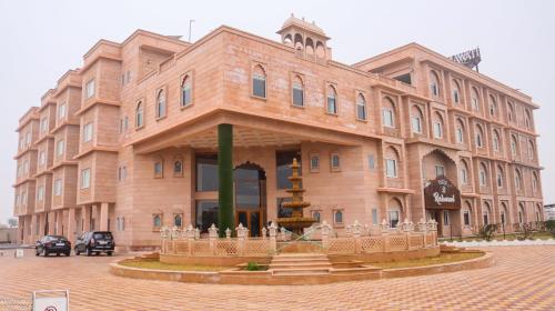 a large wooden building with a fountain in front of it at The Grand Shekhawati in Rāmsir