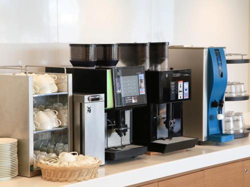 a coffee machine on a counter in a kitchen at Hiroshima Tokyu REI Hotel in Hiroshima