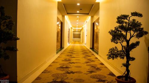a hallway with a carpeted floor in a building at The Grand Shekhawati in Rāmsir