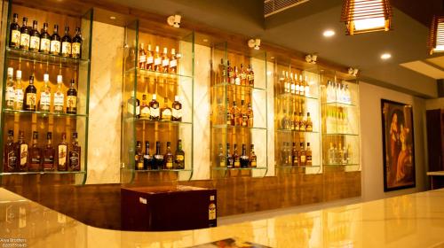 a bar with a bunch of bottles of alcohol at The Grand Shekhawati in Rāmsir