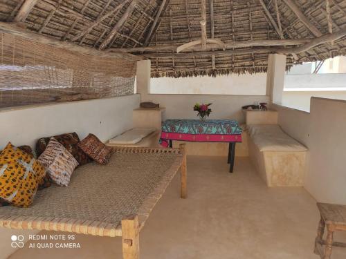 a room with a couch and a table in it at Furaha House in Shela