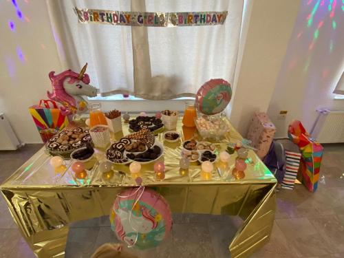 a birthday party with a table full of cookies and donuts at Pensiunea Anotimpuri Bran in Bran