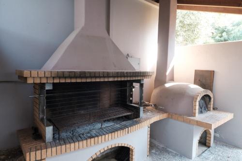 a kitchen with an outdoor oven in a room at VILLA KONSTANTINA in Nafplio