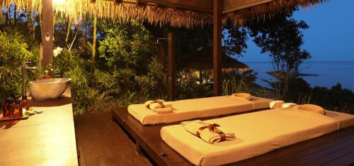 two beds on a porch with the ocean in the background at Sangsuri Villa 1 in Choeng Mon Beach