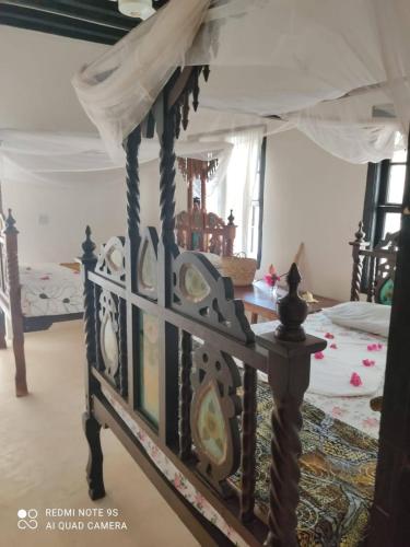 a bedroom with a bed with a canopy at Furaha House in Shela