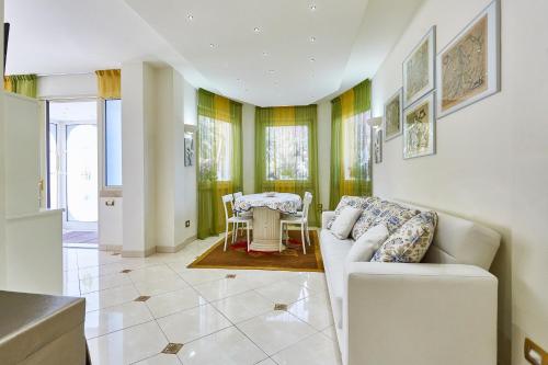 a living room with a couch and a table at Villa Azzurra Depandance con piscina in Desenzano del Garda