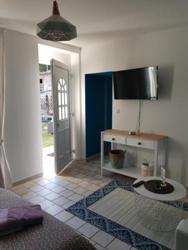 a living room with a tv on the wall at Ideal pour une pause in Saint-Georges-sur-Cher