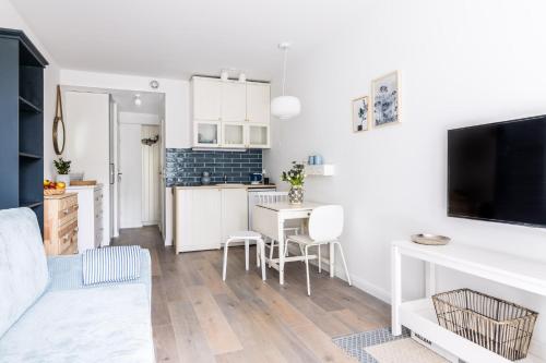 a living room with a kitchen and a dining room at Nice Sopot in Sopot