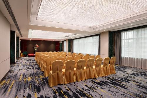 a conference room with a row of chairs in it at Asia International Hotel Guangdong in Guangzhou