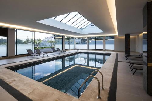 a swimming pool with a skylight in a building at Selection AL in Sermonde