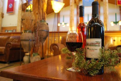 two bottles of wine sitting on a table with a glass at Lied Lodge at Arbor Day Farm in Nebraska City