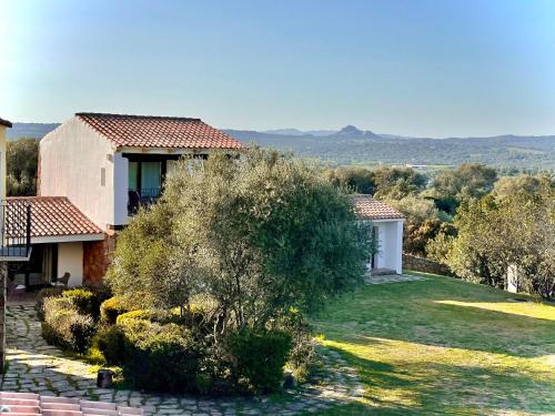 a house with a garden with a view at Punta D'Acu Country Resort in Arzachena