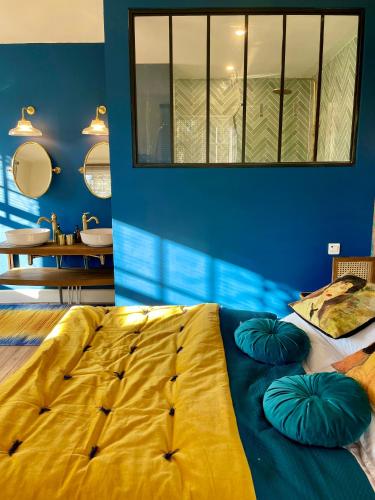 a bedroom with a large bed with two pillows on it at Aux Jolies Sources in Saint-Aubin-sur-Scie