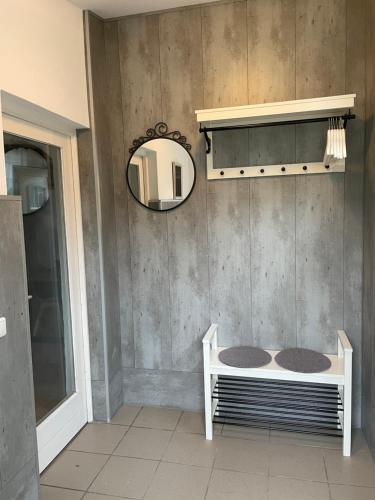 a bathroom with a mirror and a bed in a room at Lindenhof Habernis in Steinberg