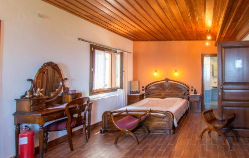 a bedroom with a bed and a desk and a table at Traditional Guesthouse 4 Epoches in Zagora