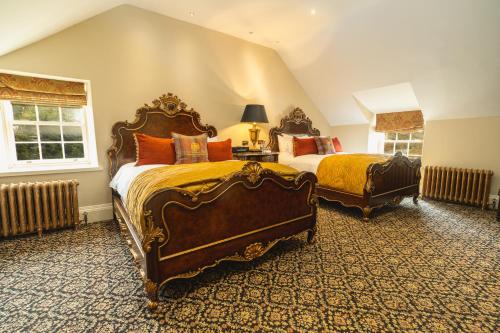a large bedroom with two beds and two windows at Trump MacLeod House & Lodge, Scotland in Balmedie