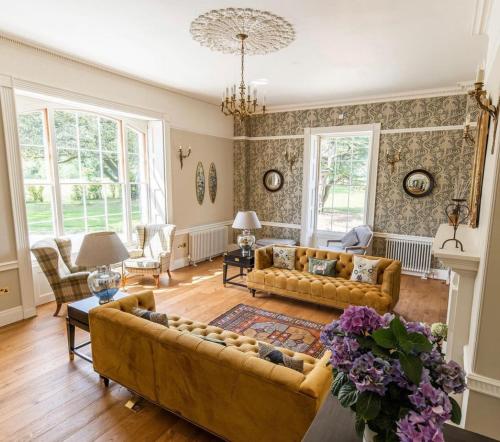 a living room with a couch and a table at Reymerston Hall in Norwich