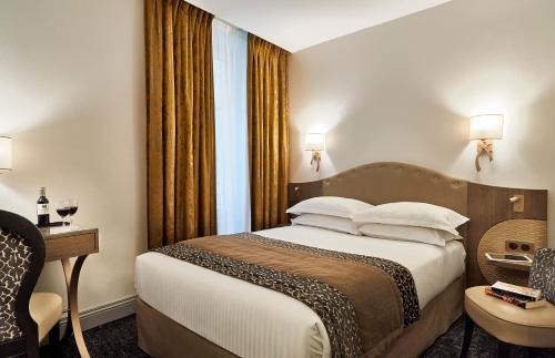 a hotel room with a bed and a window at Best Western Premier HBEO Bordeaux Centre in Bordeaux