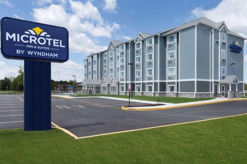 a hotel with a sign in front of a parking lot at Microtel Inn & Suites by Wyndham Georgetown Delaware Beaches in Georgetown