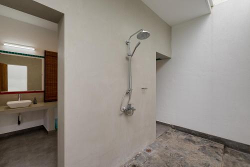 a bathroom with a shower and a sink at Tara Watergate in Tissamaharama