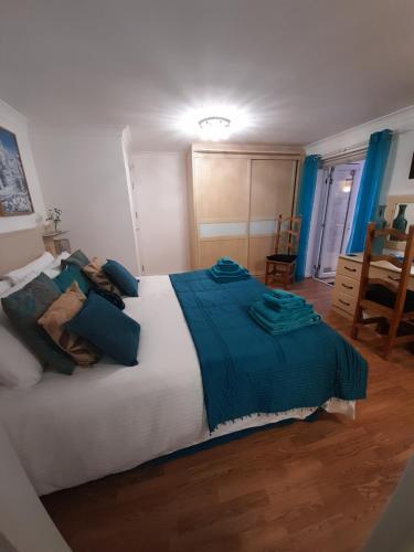 a bedroom with a large bed with blue sheets at North Shore Lodge Skegness in Skegness