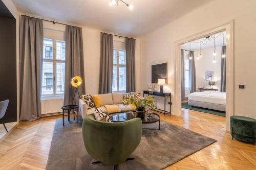 a living room with a couch and a bed at josef's home I Pink Flamingo I Deluxe Suite in Vienna