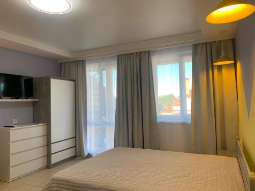 a bedroom with a bed and a window at Апартаменти Маяк in Odesa