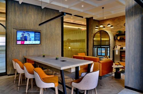 a dining room with a table and chairs at Courtyard Hotel Waterfall City in Midrand