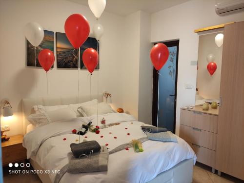 a bedroom with red balloons and a bed at ARAD-DEAD SEA BASHIRIS PLACE in Arad