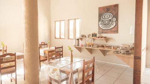a dining room with a glass table and chairs at Pousada Porto Da Barra in Porto Seguro