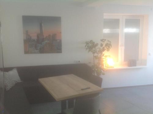 a living room with a table and a window at Hotel Restaurant Fritz in Gronau