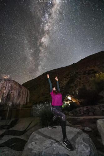a woman standing on a rock under a starry sky at Reset Elqui in Alcoguaz