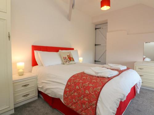a bedroom with a large bed with two night stands at The Loft in Holsworthy