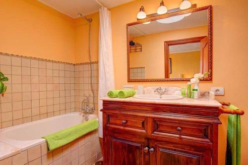 a bathroom with a tub and a sink and a mirror at Modern Villa in Nazaret with Private Pool in Nazaret