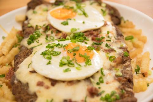 a plate of food with eggs and french fries at Los Lagos Resort Hotel in Capiatá