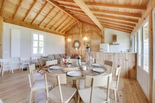 a dining room with a table and chairs at Villa Mimbeau in Cap-Ferret