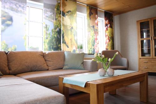 a living room with a couch and a coffee table at Weingut Markus Junglen in Kröv