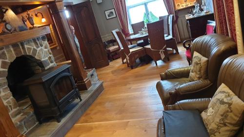 a living room with a fireplace and a couch at Le Prangeleux in Tenneville