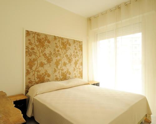 アラッシオにあるCasa Vacanze Meditの白いベッドルーム(ベッド1台、窓付)