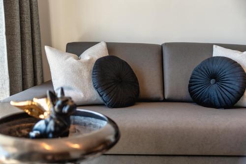 a couch with pillows and a bowl on a table at Ski & Nature Apartment in Mauterndorf
