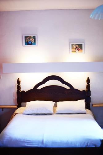 a bedroom with a large bed with a wooden headboard at le gite d'Eliane in Masevaux