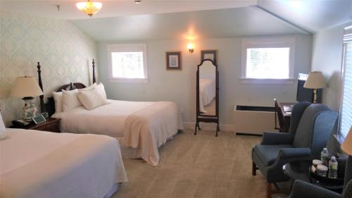 a hotel room with two beds and a chair at Black Point Inn in Scarborough